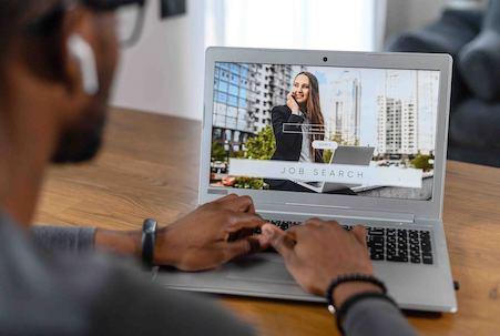 Person using a laptop to search for jobs, the screen showing 