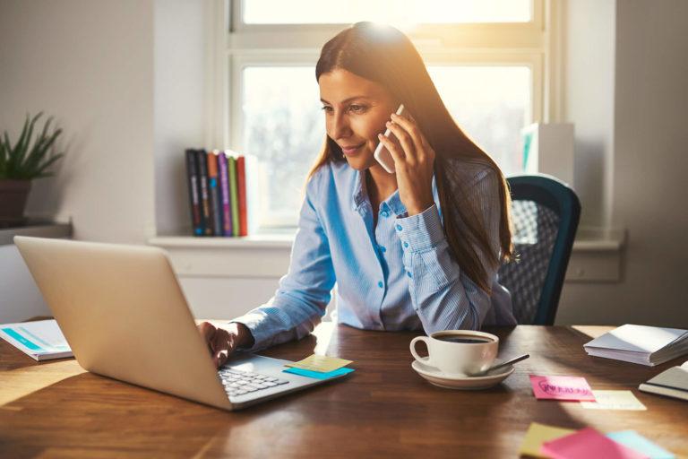 Female talking on the phone in her home office