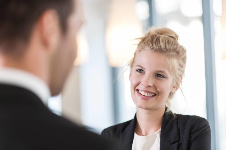 Female smiling while listening to potential employer