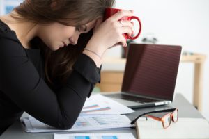 Women tired and stressed while working