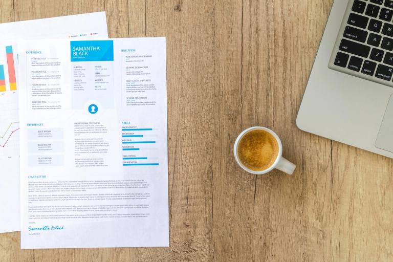 Resume on desk showing how to list security clearance on a resume
