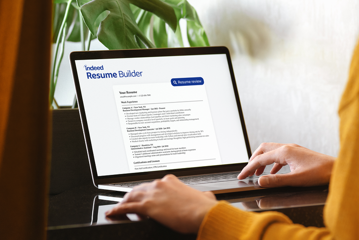 Person reviewing a resume on resume dot com