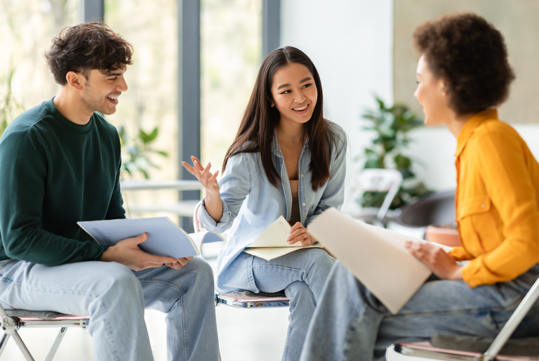 A group of college students talking about career plans and job applications in a school environment.